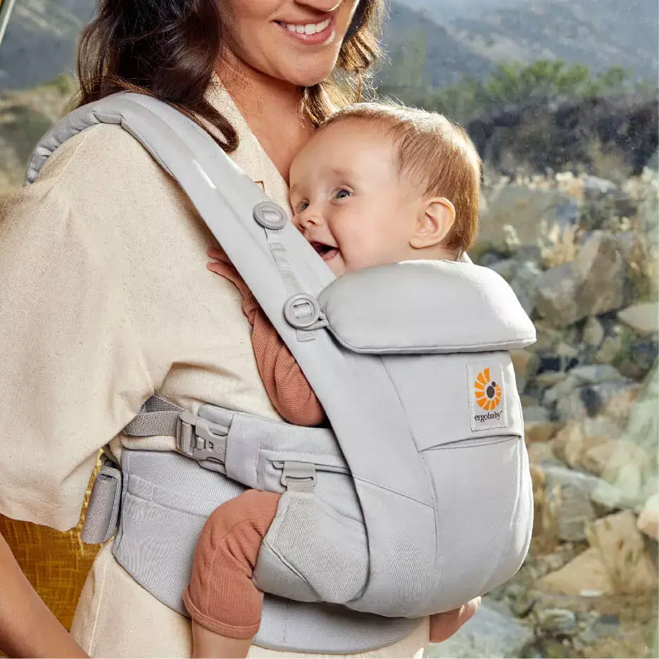 mother carrying child in baby carrier Omni Dream